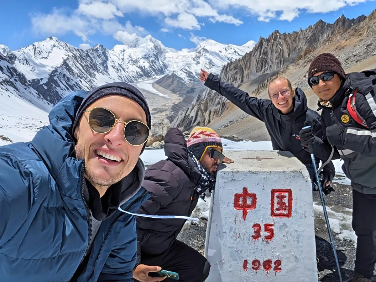 Trekkers with the border sign