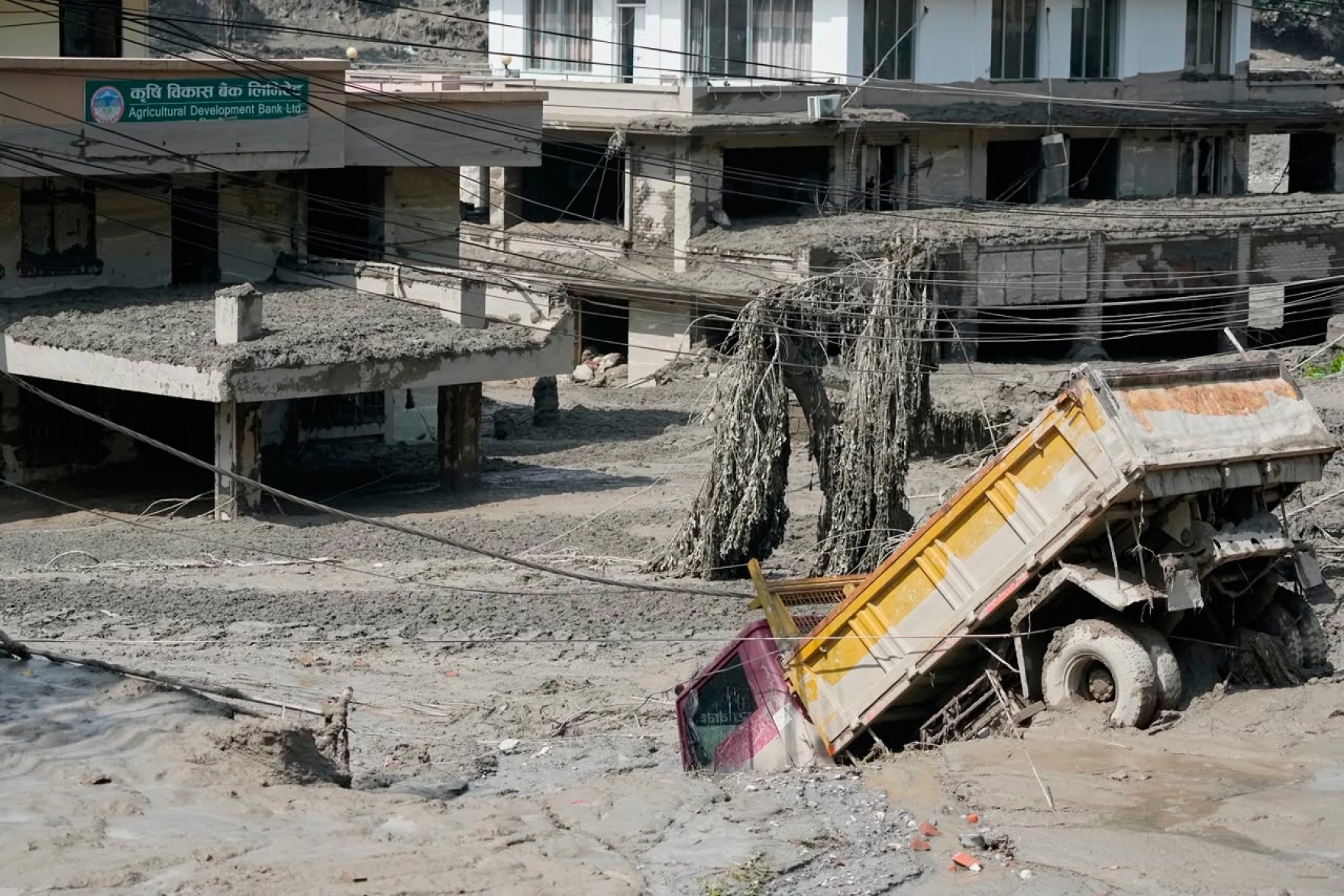 Houses and Vehicles covered in mud after flood