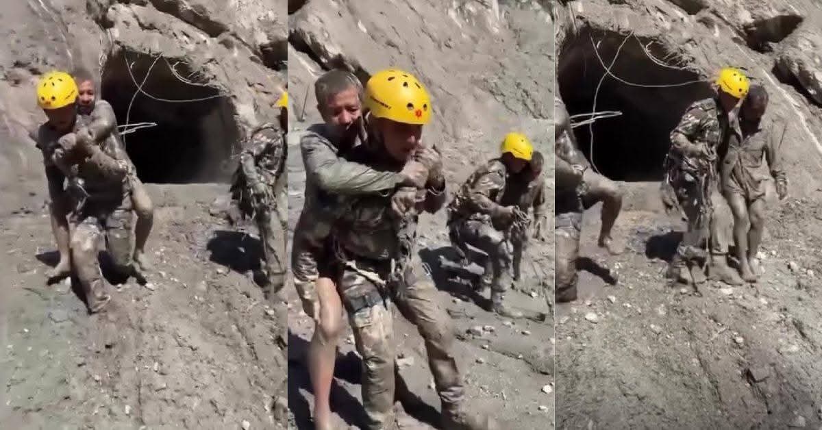 Man being rescued after being covered in mud