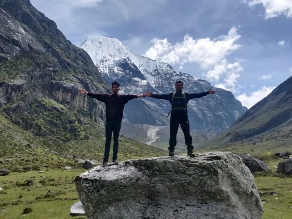 Two People Posing Over A Rock In Rolwaling